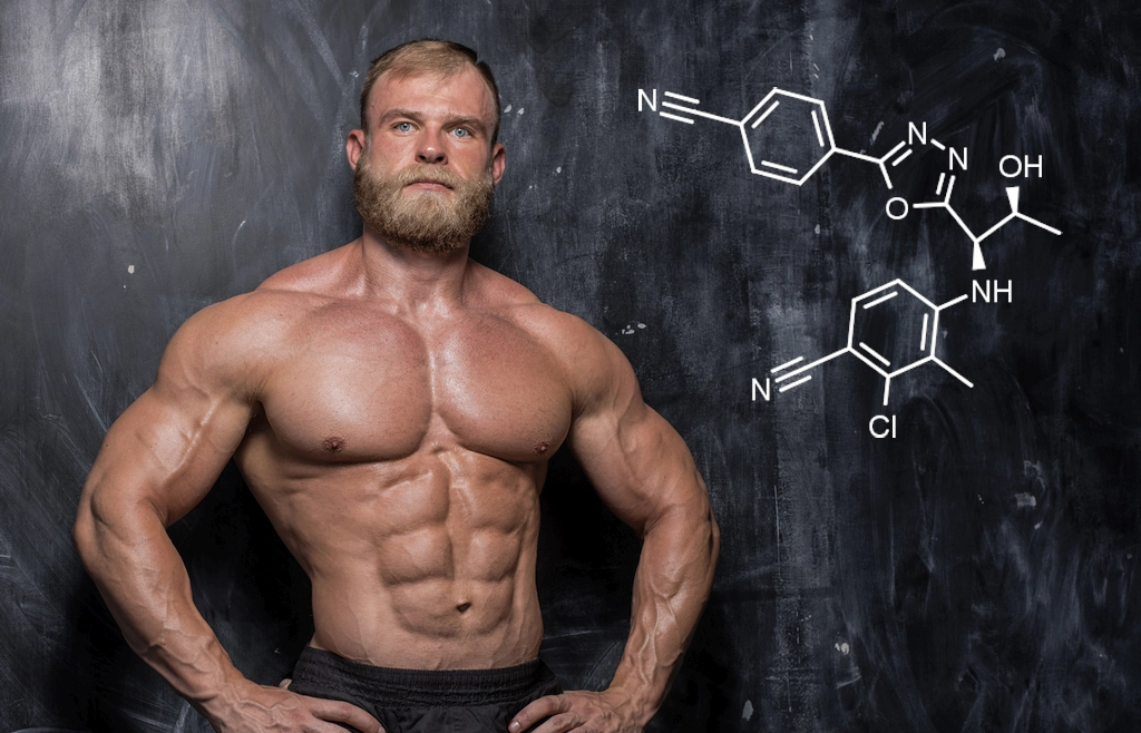 Bodybuilder standing in front of blackboard with RAD-140 (Testolone) chemical structure diagram