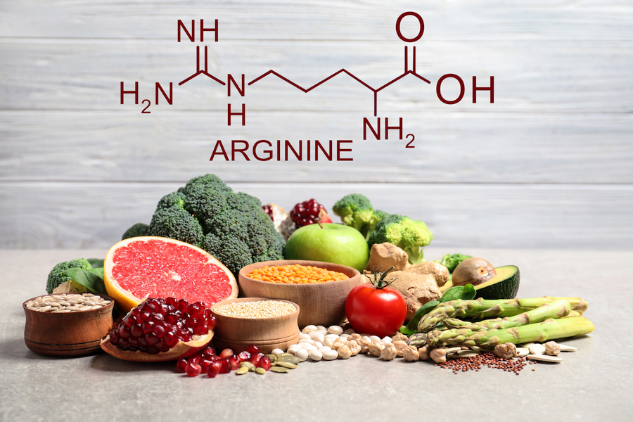 Graphic of the L-arginine chemical structure over a table filled with arginine-rich foods.
