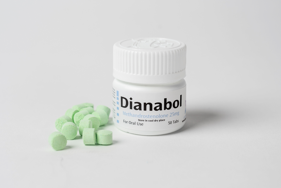 Dianabol container and pills on white tabletop