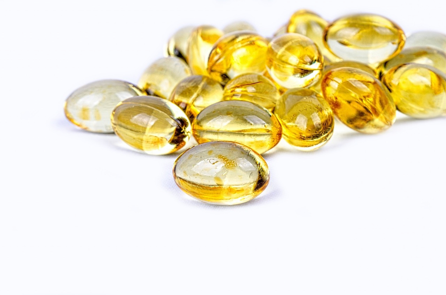 Vitamin D capsules on a white background