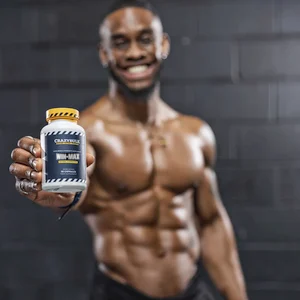 Shirtless male bodybuilder holding ups a bottle of Win-Max
